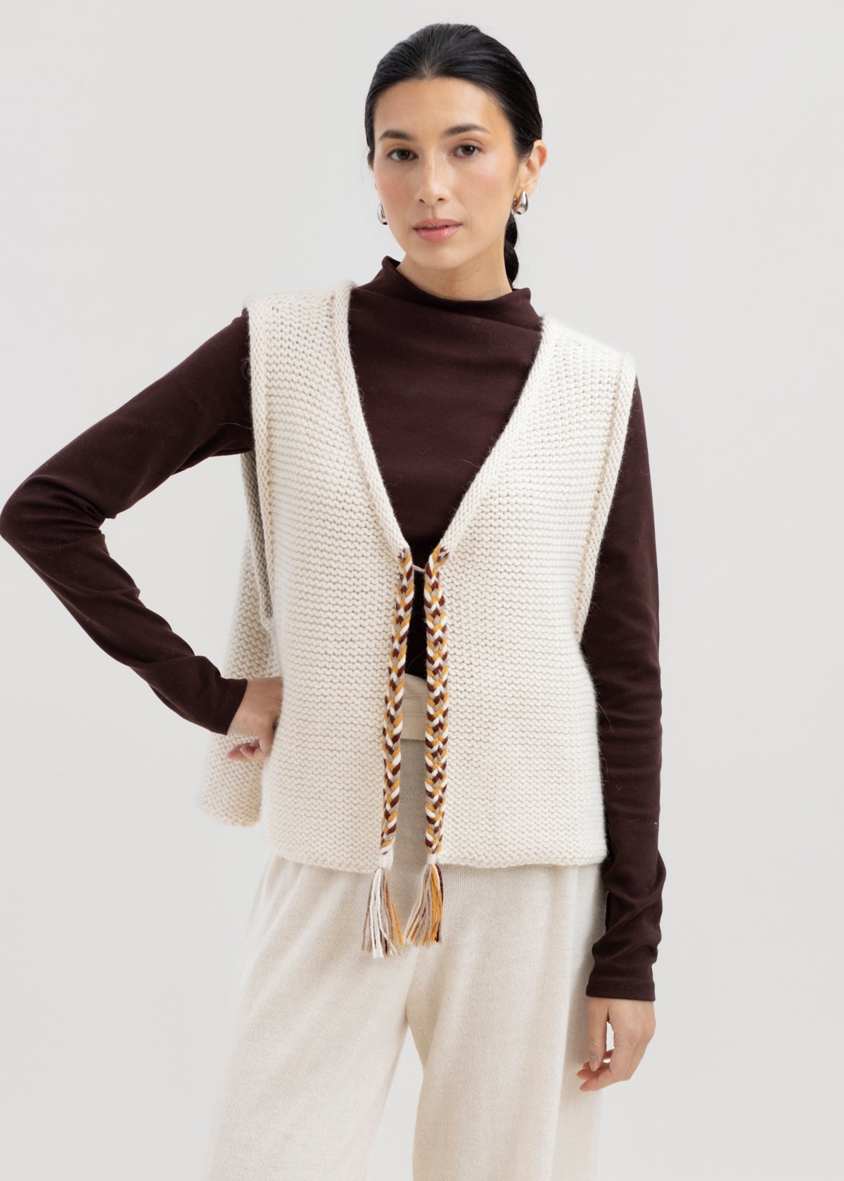 Vela Braid Vest in Ivory, baby alpaca knit vest with hand-braided trim by Ahblo, worn by model