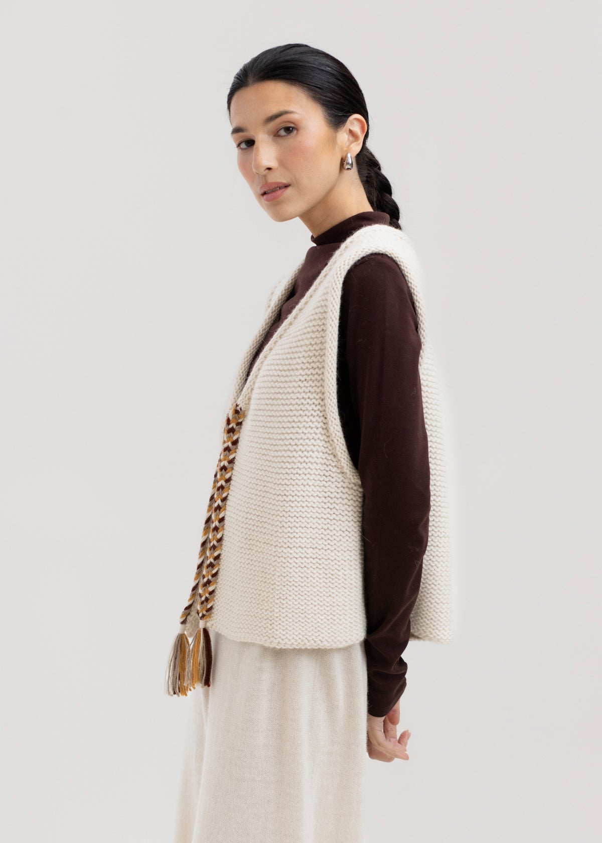 Vela Braid Vest in Ivory, baby alpaca knit vest with hand-braided trim by Ahblo, worn by model