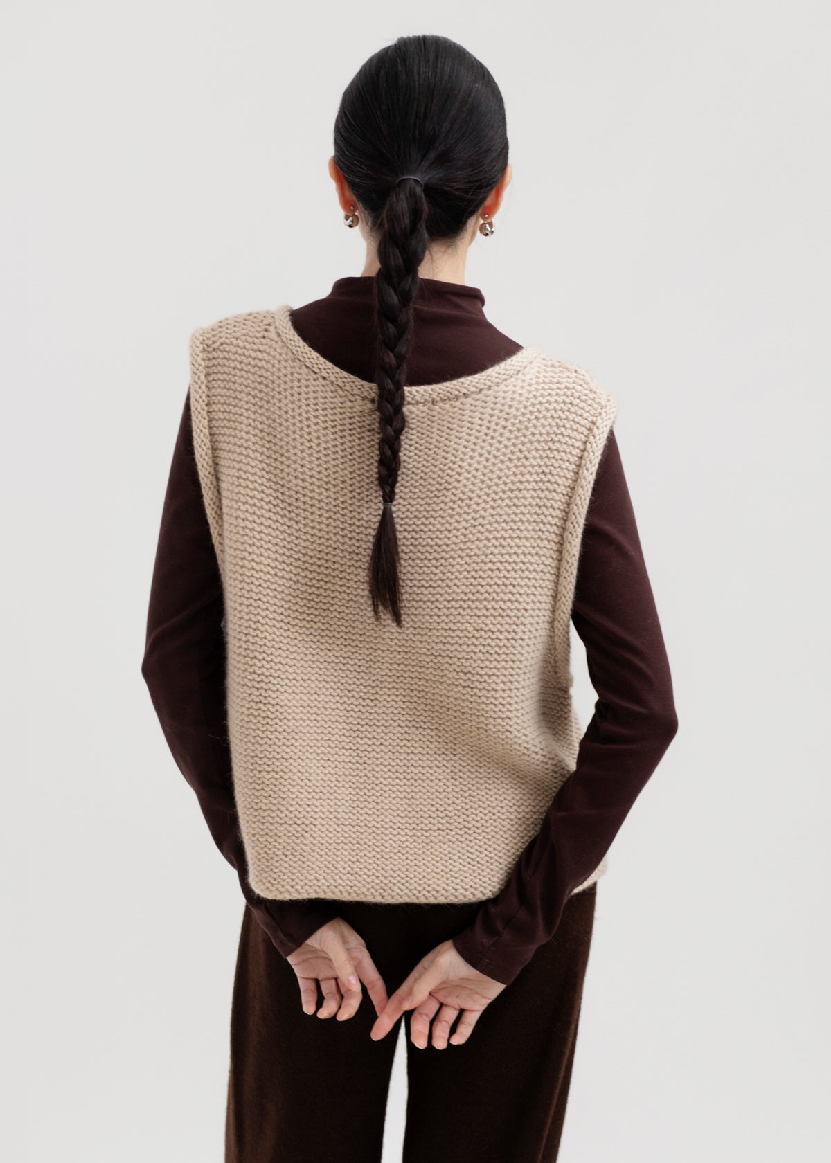 Vela Braid Vest in Praline, baby alpaca knit vest with hand-braided trim by Ahblo, worn by model