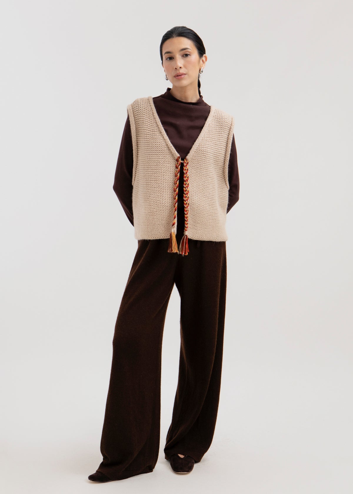Vela Braid Vest in Praline, baby alpaca knit vest with hand-braided trim by Ahblo, worn by model