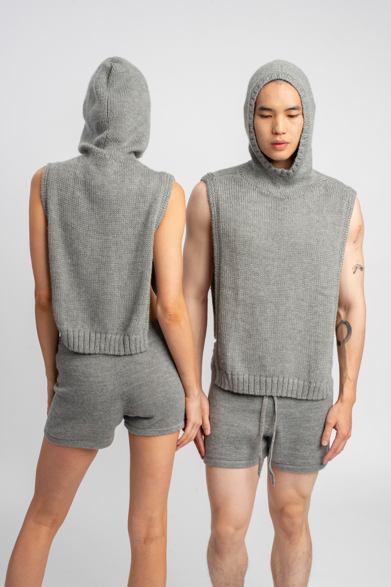 Models wearing knitwear alpaca wool light grey shorts, front and back