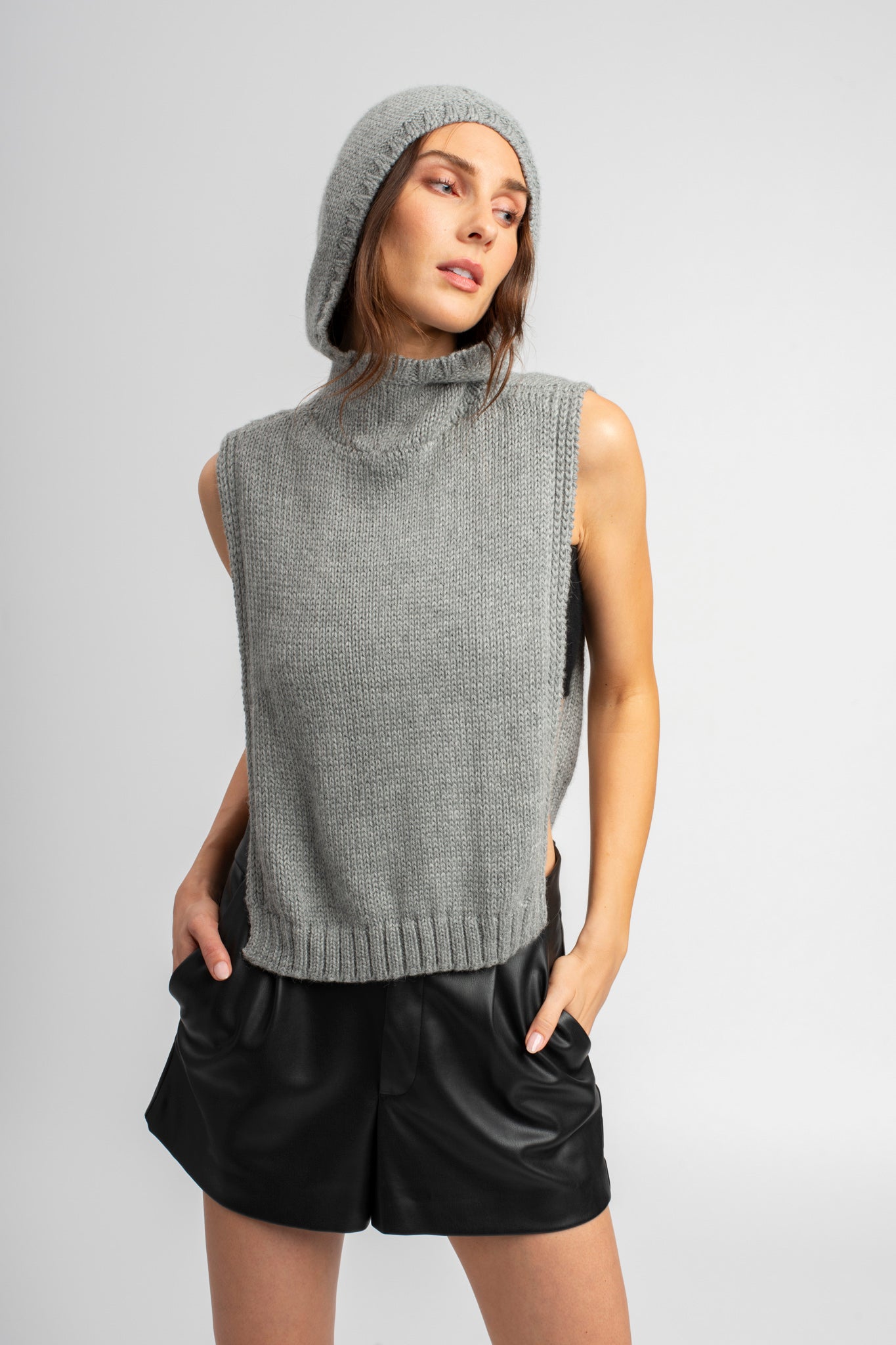 Model wearing poncho in light grey alpaca wool, front
