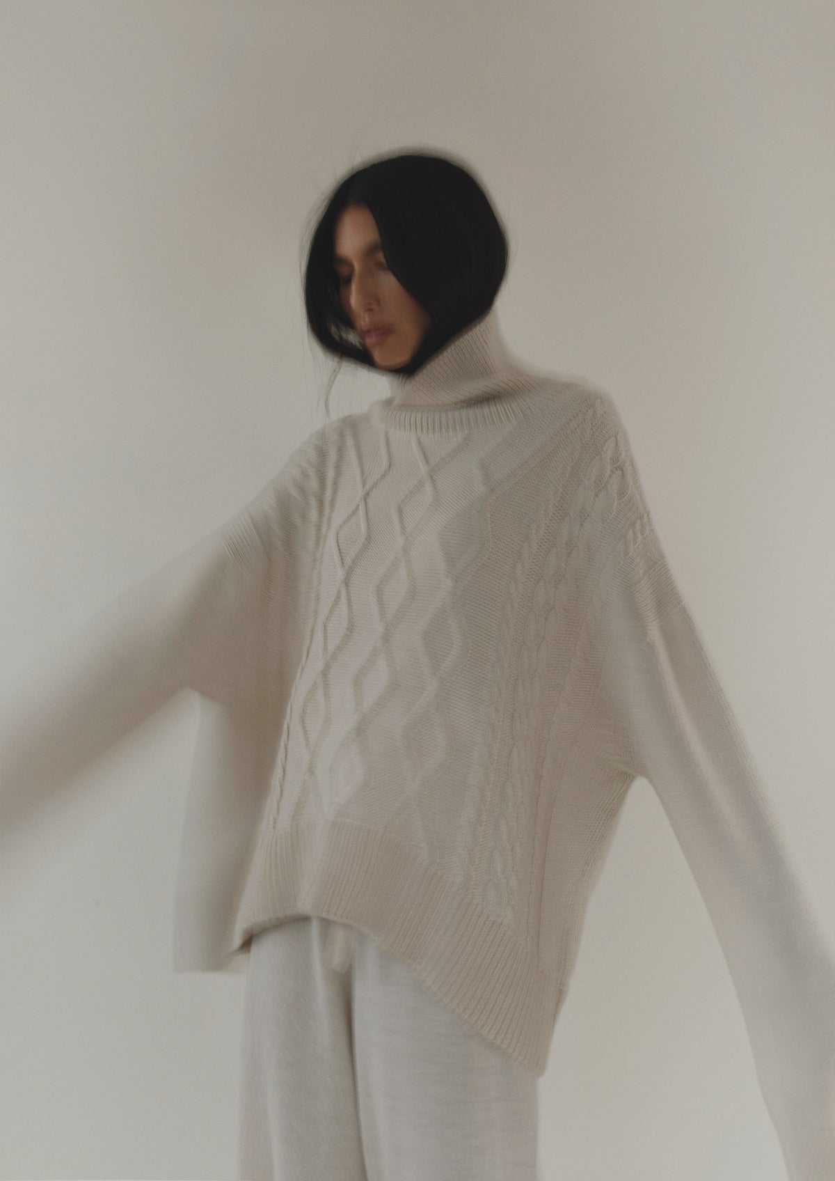 sierra cable sweater cream on model blur