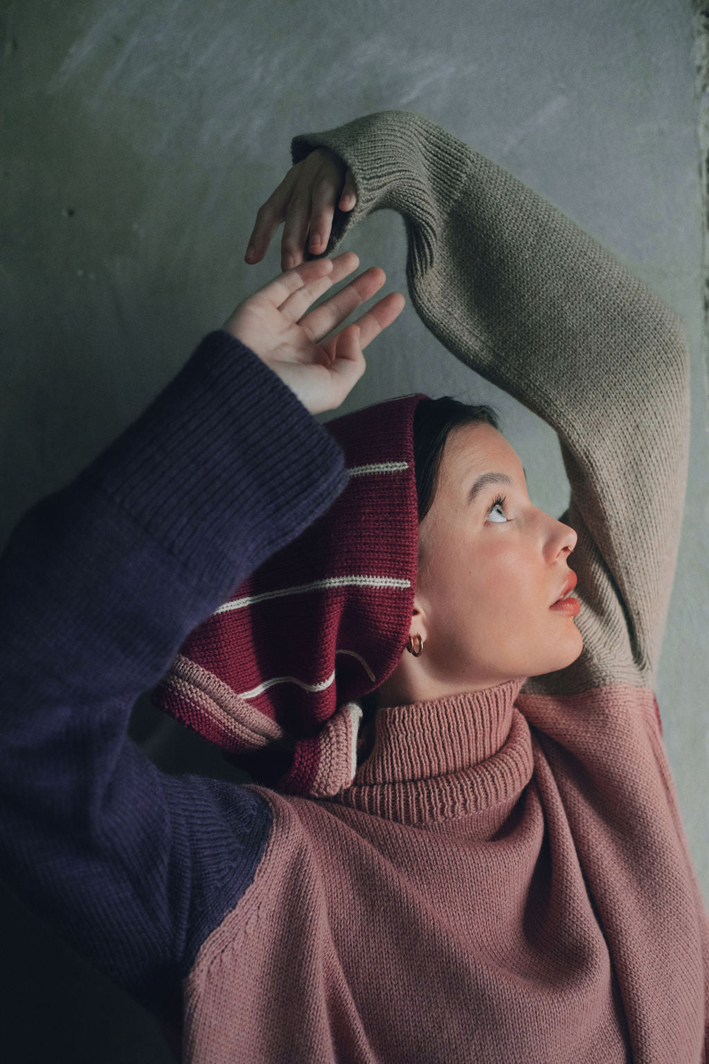 Model wearing oversized sweater in multi-color pink alpaca wool, close-up